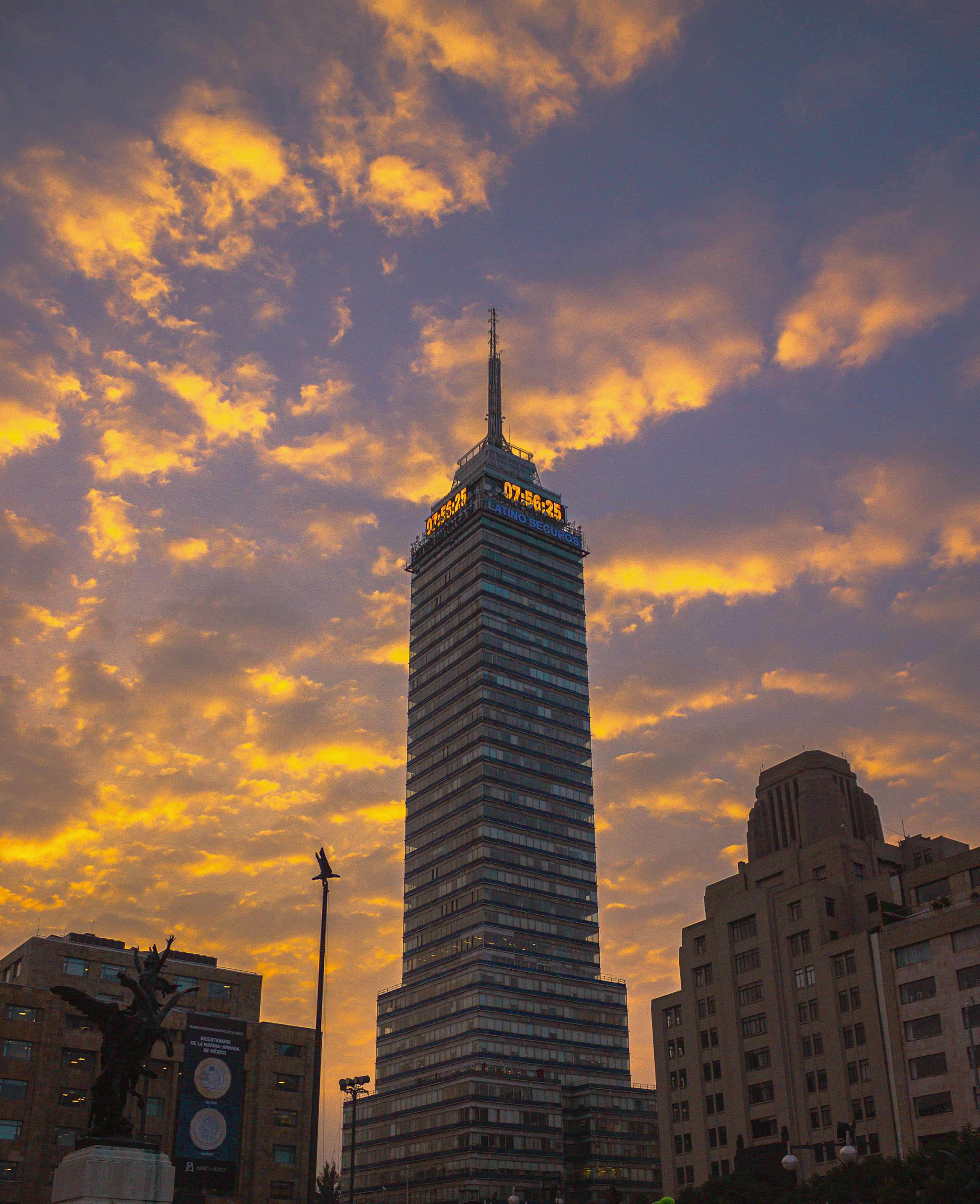 Stunning view of Torre Latinoamericana at sunset with a dramatic sky in Mexico City.